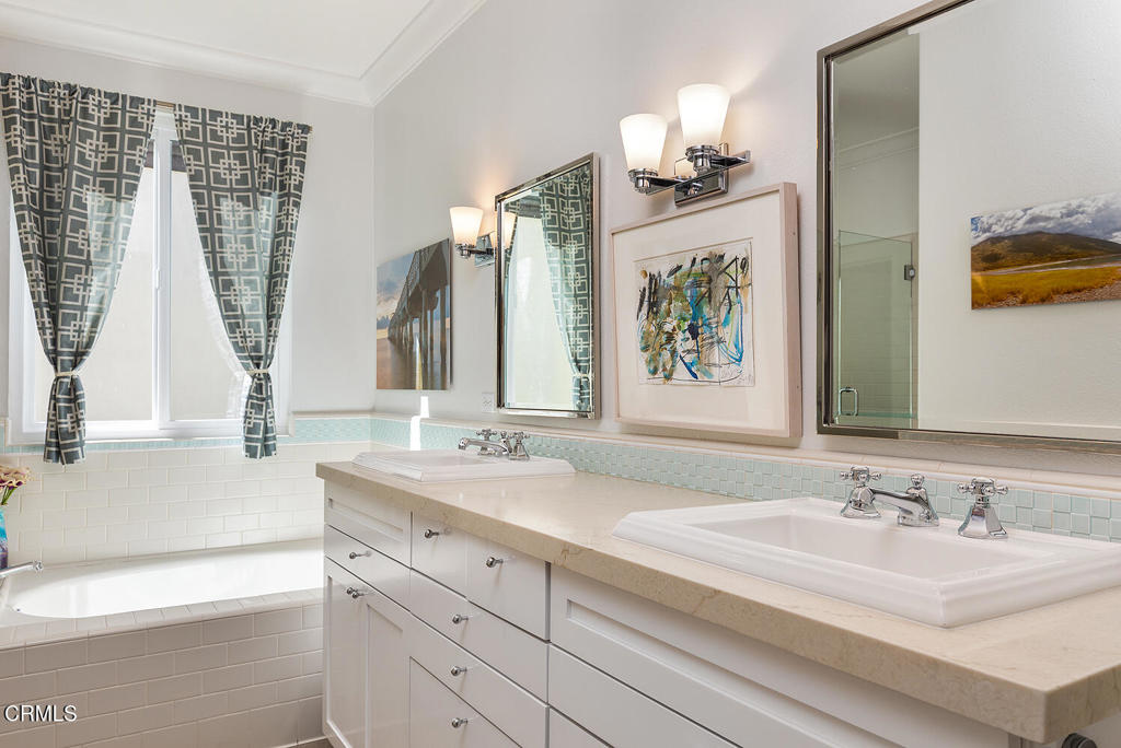 411 22nd Street Huntington Beach, CA 92648 - Photo 30 of 38 a bathroom with double vanity sink a mirror and a bathtub