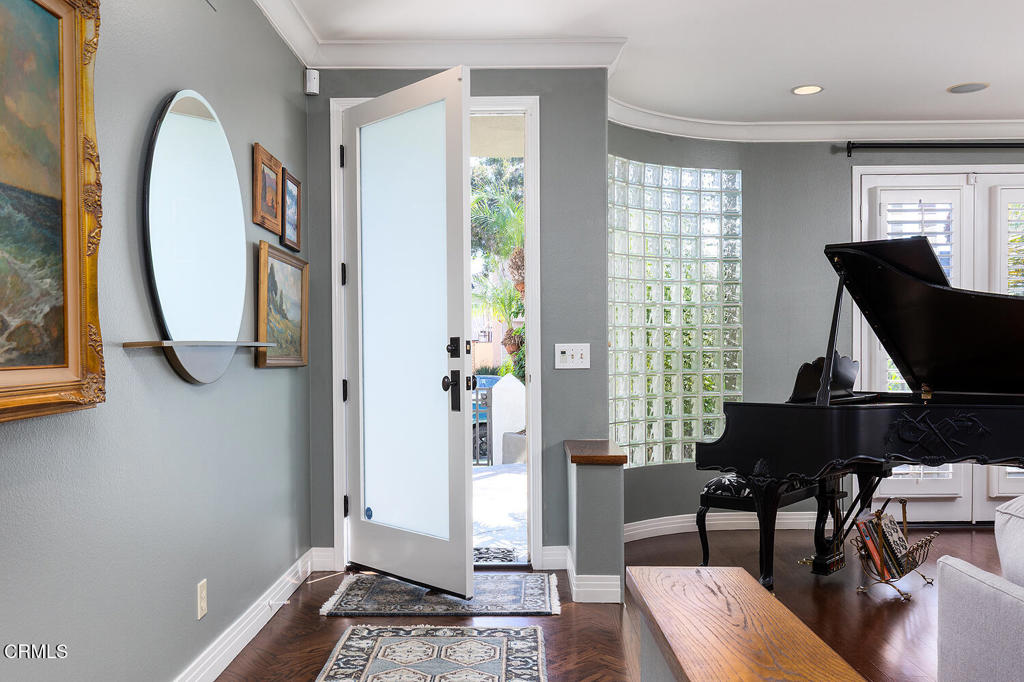 411 22nd Street Huntington Beach, CA 92648 - Photo 4 of 38 a living room with furniture a window and a chandelier