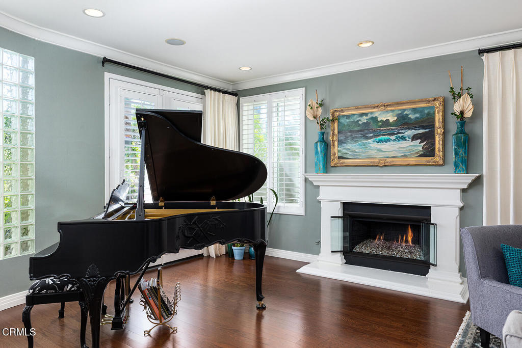 411 22nd Street Huntington Beach, CA 92648 - Photo 6 of 38 a living room with furniture a fireplace and a large window