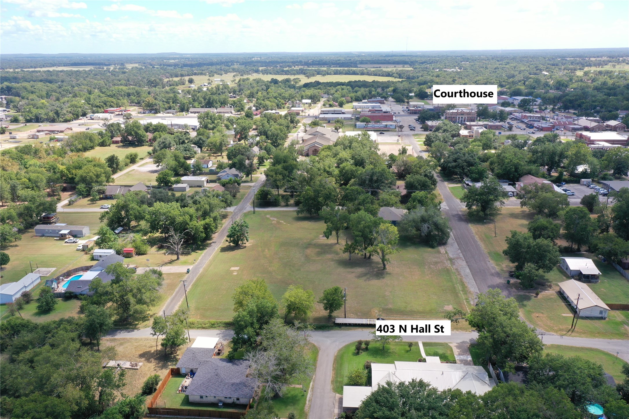 403 North Hall Street Fairfield, TX 75840 - Photo 3 of 45 an aerial view of residential houses with outdoor space and trees