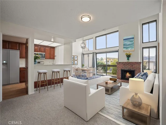 a living room with furniture a fireplace and a large window