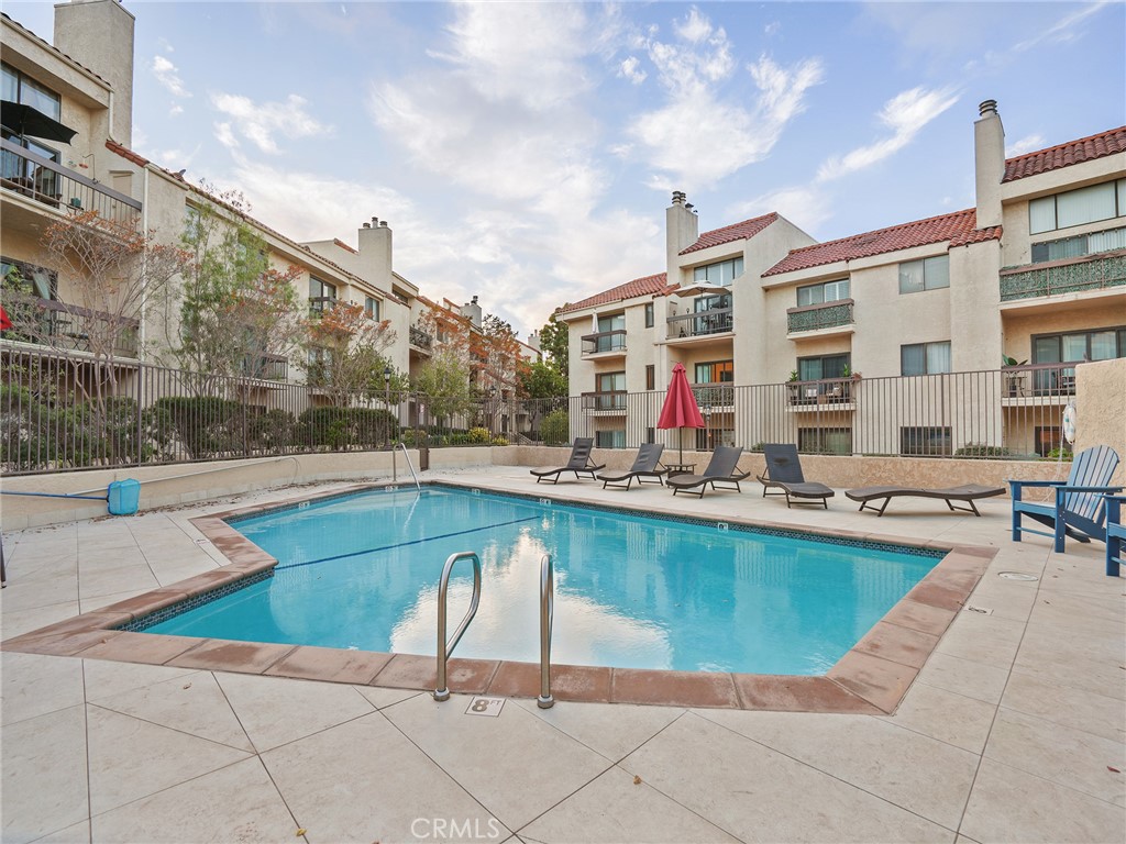 8180 Manitoba Street, Unit 302 Playa del Rey, CA 90293 - Photo 20 of 31 a swimming pool with outdoor seating and yard in the back