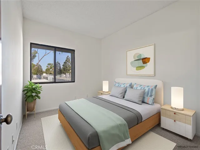 a bedroom with a bed and painting on the wall