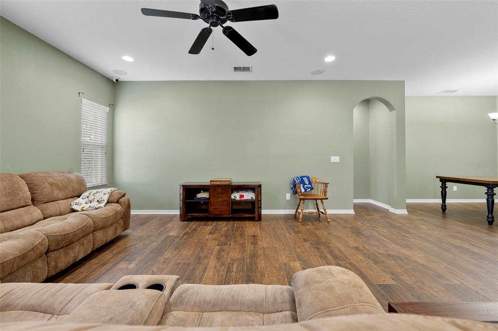 632 Winthrop Drive Spring Hill, FL 34609 - Photo 17 of 49 a living room with furniture and a wooden floor