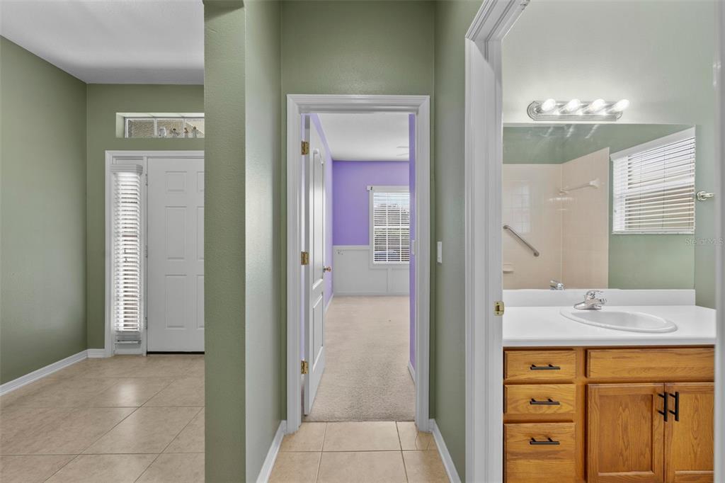 632 Winthrop Drive Spring Hill, FL 34609 - Photo 25 of 49 a bathroom with a double vanity sink a mirror and a shower