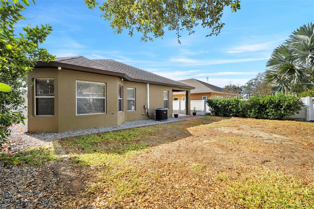 632 Winthrop Drive Spring Hill, FL 34609 - Photo 47 of 49 a view of a house with a yard and potted plants