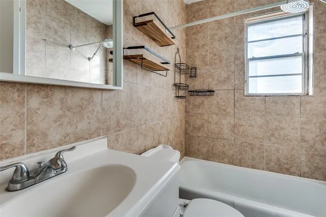 a bathroom with a sink a mirror and toilet