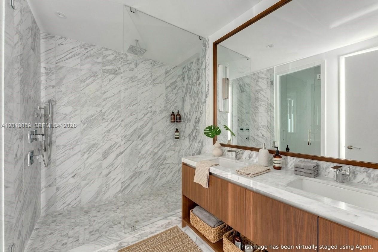 175 Southeast 25th Road, Unit 3601 Miami, FL 33129 - Photo 13 of 27 a bathroom with a granite countertop sink a mirror and shower