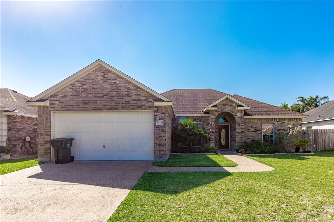 8209 Tango Circle Corpus Christi, TX 78414 - Photo 1 of 28 a front view of a house with a yard and garage