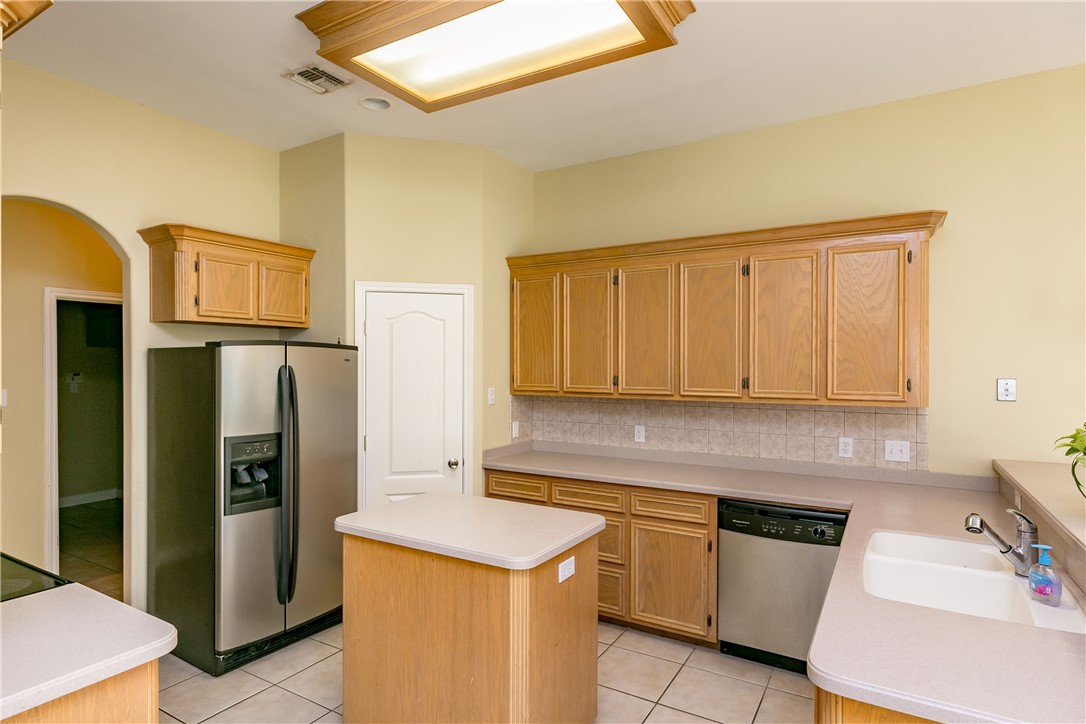 8209 Tango Circle Corpus Christi, TX 78414 - Photo 5 of 28 a kitchen with stainless steel appliances granite countertop a refrigerator and a stove top oven