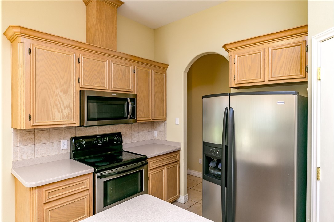 8209 Tango Circle Corpus Christi, TX 78414 - Photo 8 of 28 a kitchen with stainless steel appliances granite countertop a refrigerator sink and stove