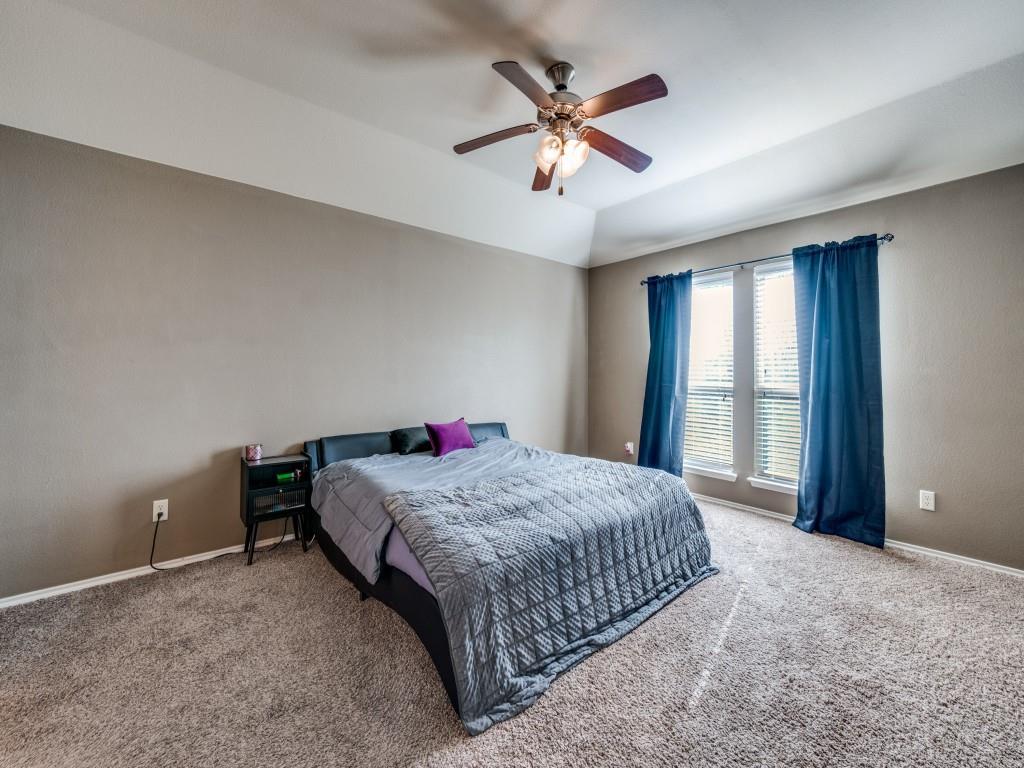 2313 Luscombe Lane Anna, TX 75409 - Photo 16 of 30 a bedroom with a bed and a chandelier