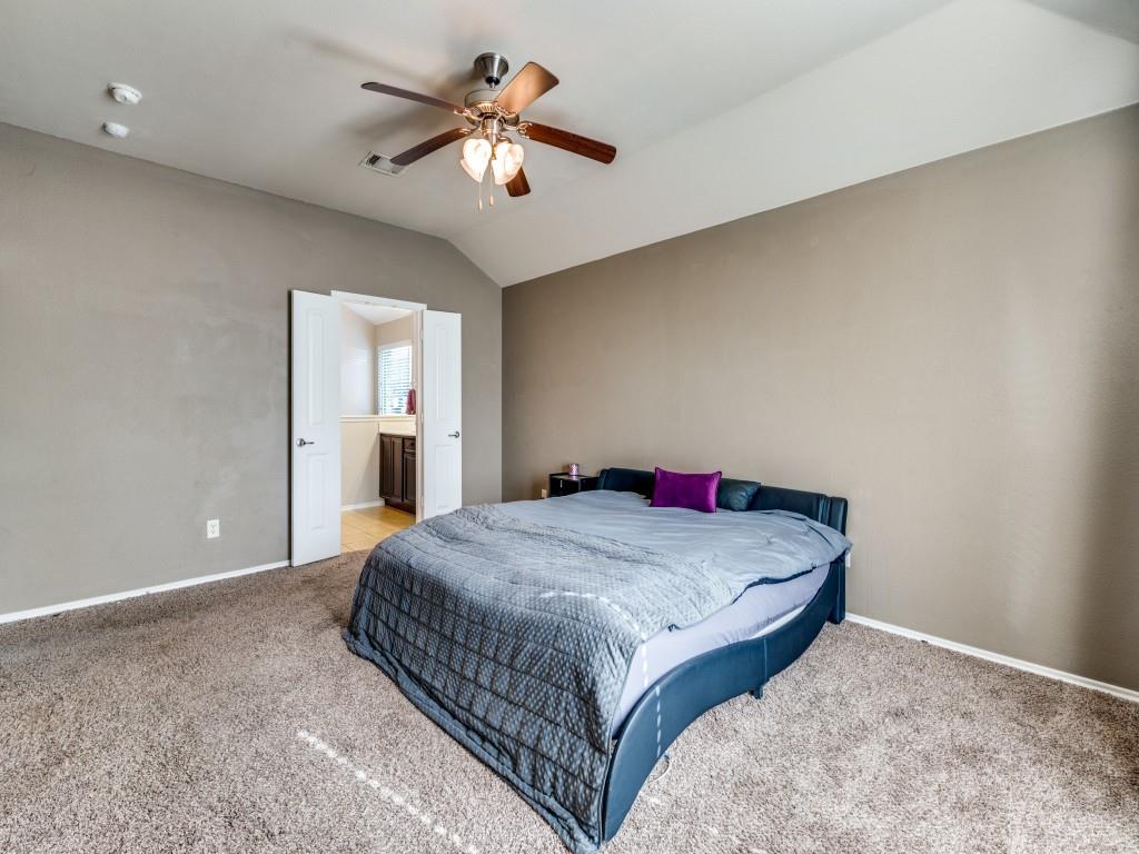 2313 Luscombe Lane Anna, TX 75409 - Photo 17 of 30 a bedroom with a bed and a chandelier