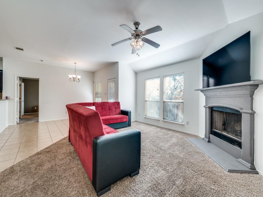 2313 Luscombe Lane Anna, TX 75409 - Photo 4 of 30 a living room with furniture a flat screen tv and a fireplace