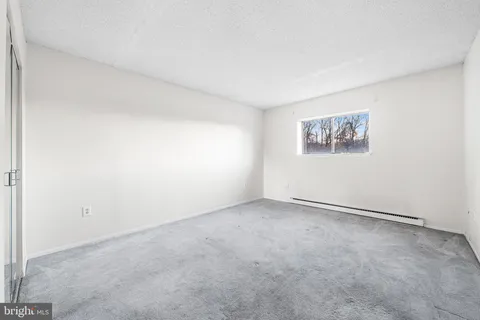an empty room with a refrigerator