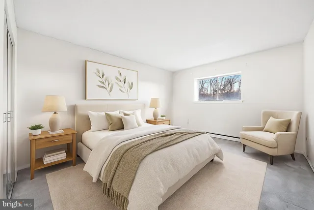 a bedroom with a bed and a couch