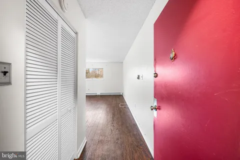 a view of a hallway with wooden floor