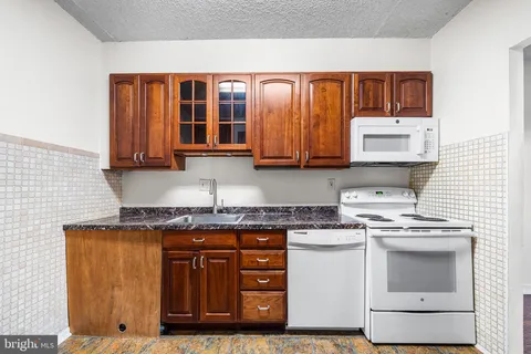 a kitchen with stainless steel appliances granite countertop a stove and a microwave