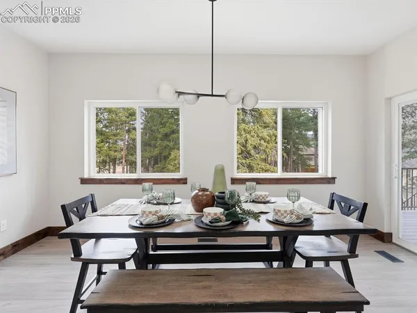 a view of a dining room with furniture window and outside view