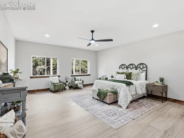 a spacious bedroom with a bed and a couch