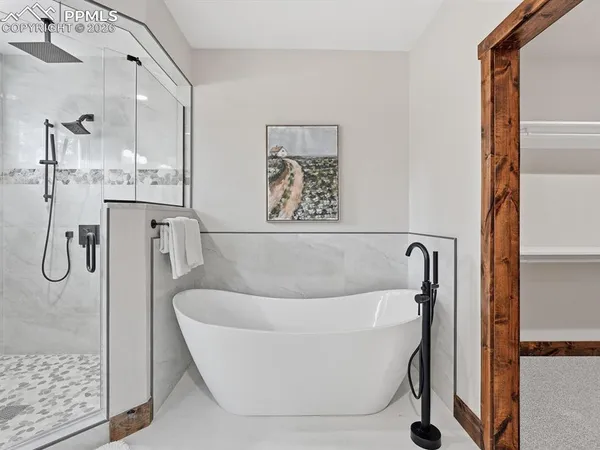 a white bath tub sitting next to a bathroom sink