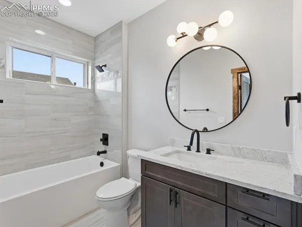 a bathroom with a toilet a sink and a mirror