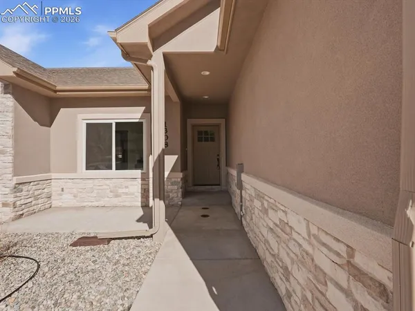 a view of a hallway with wooden floor and a fireplace