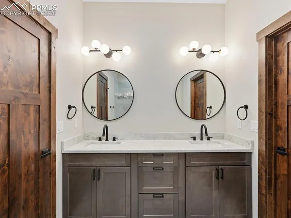 a bathroom with a double vanity sink and a mirror