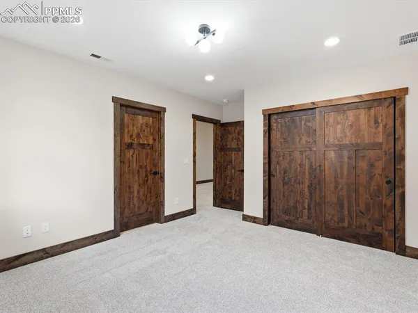 an empty room with closet area