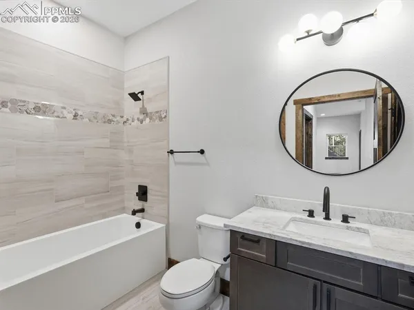 a bathroom with a toilet a sink and bathtub