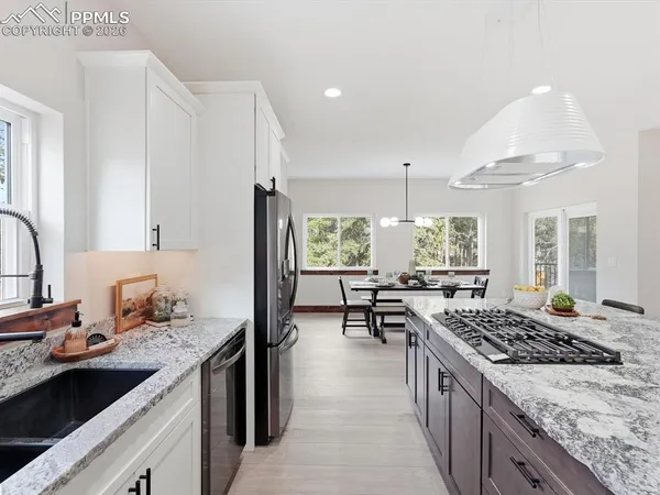 a kitchen with sink stove and cabinets