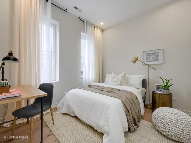 a bedroom with a bed and chair