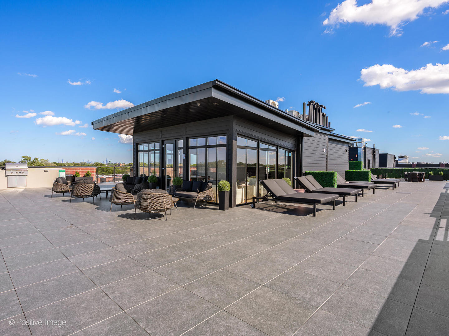 2801 Thatcher Avenue, Unit 303 River Grove, IL 60171 - Photo 26 of 33 a view of a patio with table and chairs under an umbrella with a barbeque