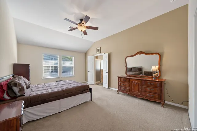 a bedroom with a bed wooden floor and window