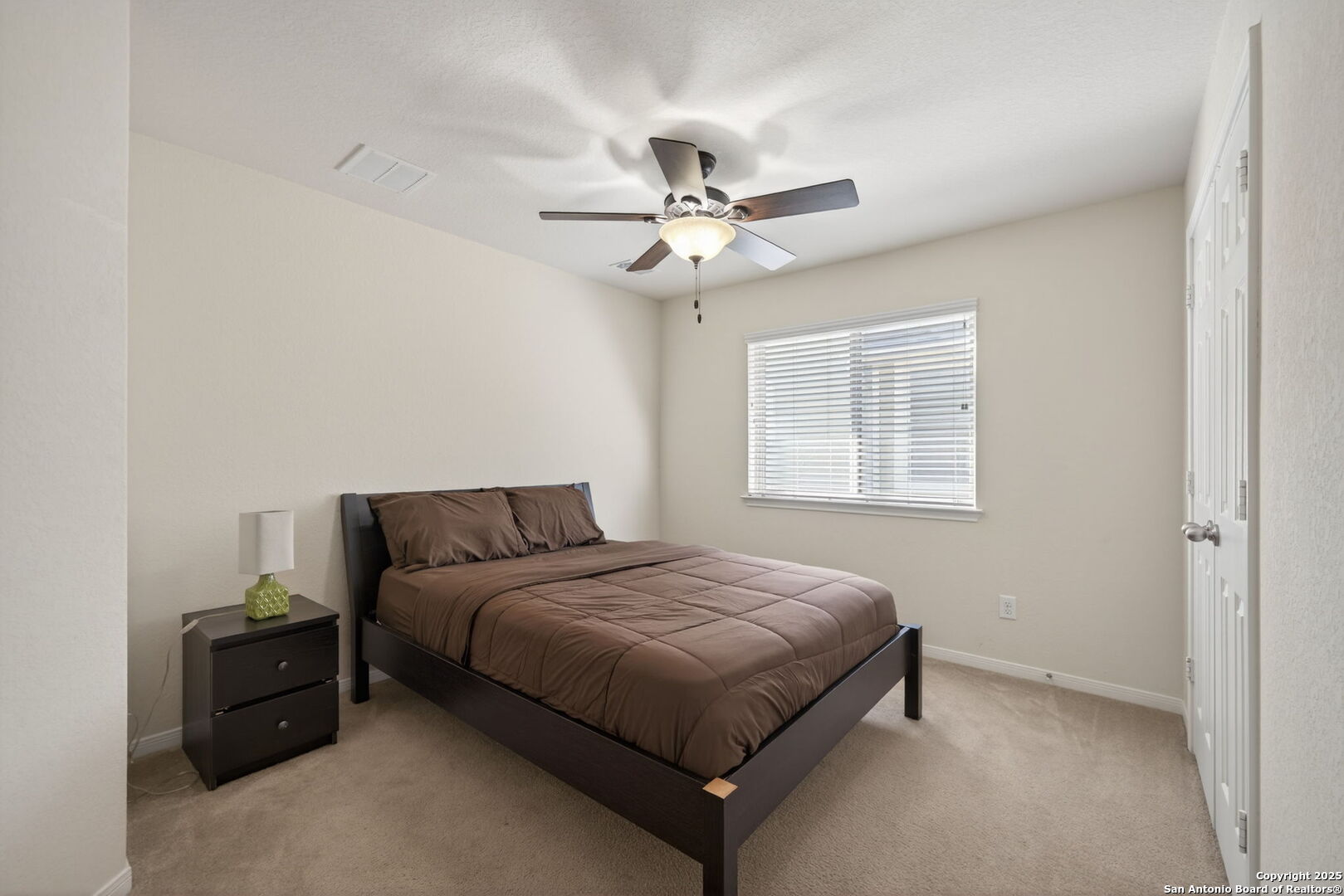 147 Brook View Cibolo, TX 78108 - Photo 21 of 29 a bedroom with a bed and a ceiling fan