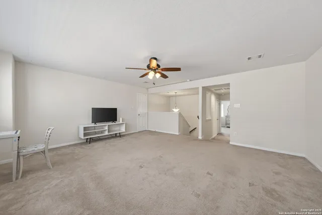 a view of livingroom with furniture and chandelier fan