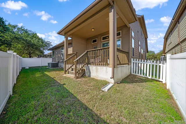 a view of a house with backyard and porch