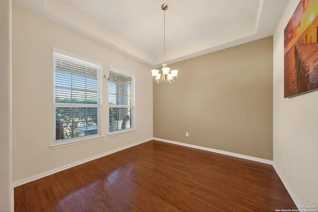 a view of a room with window and wooden floor