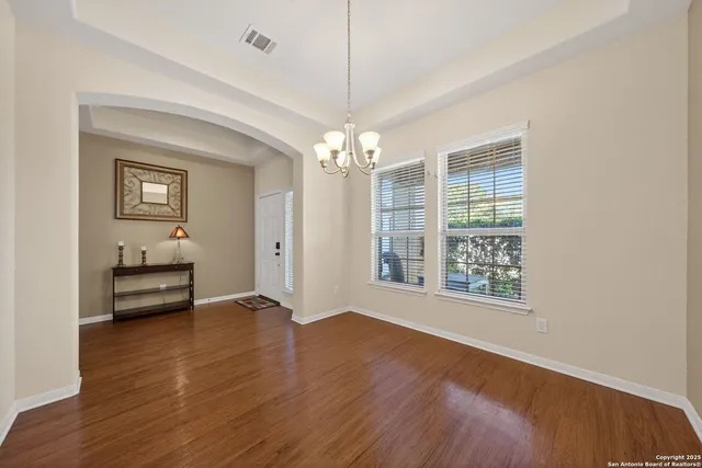 a view of a room with wooden floor and a window