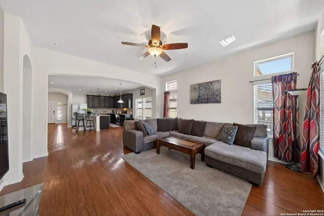 a living room with furniture and a wooden floor