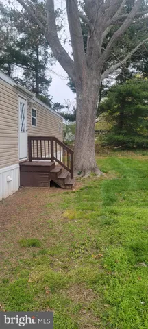 a view of a house with a yard from a lake view