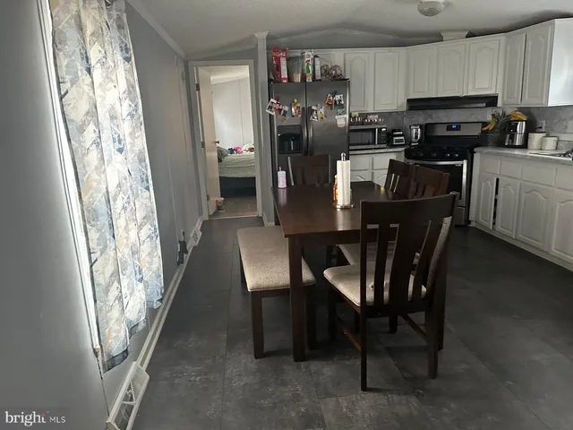 a kitchen with stainless steel appliances granite countertop a refrigerator a stove top oven a sink and dishwasher