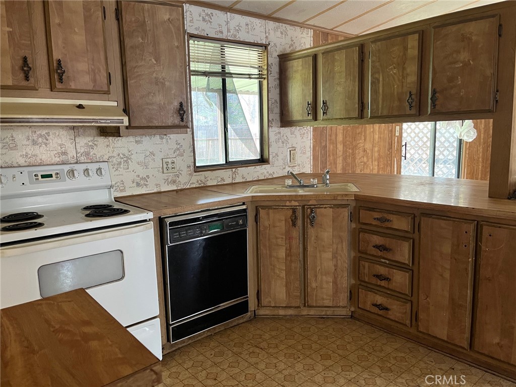 3701 Spring Valley Road Clearlake Oaks, CA 95423 - Photo 2 of 13 a kitchen with stainless steel appliances granite countertop a stove a sink and a microwave