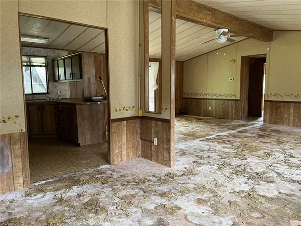 a view of a hallway with wooden cabinets
