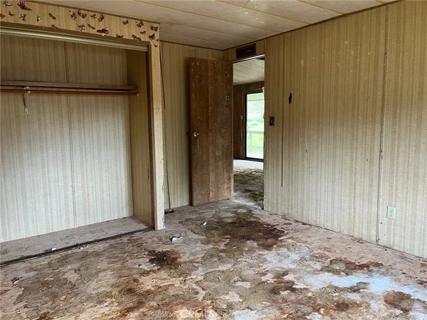 a view of a house with a wooden wall