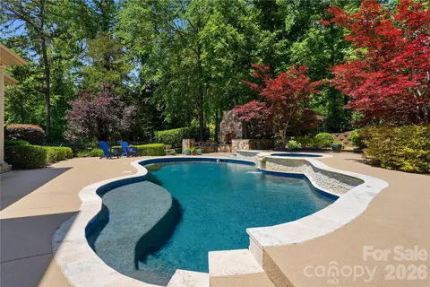 a view of house with swimming pool outdoor seating