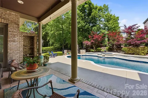 a view of a house with swimming pool and sitting area