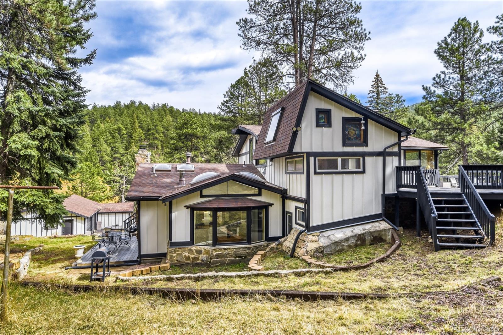 7489 South Turkey Creek Road Morrison, CO 80465 - Photo 2 of 28 a front view of a house with a yard