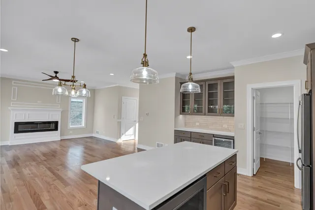a room with a table a sink and chandelier