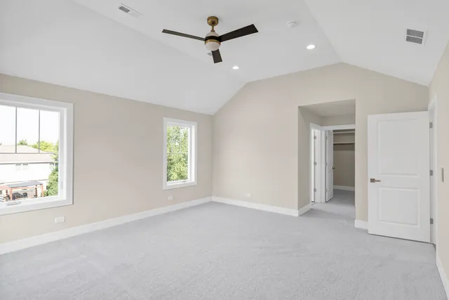a view of a livingroom with a ceiling fan and window